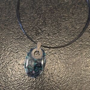 Bright jewelry pendant with leather necklace with purple and green tones